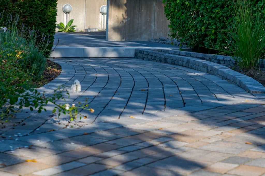 Curved paver walkway through a landscaped commercial property