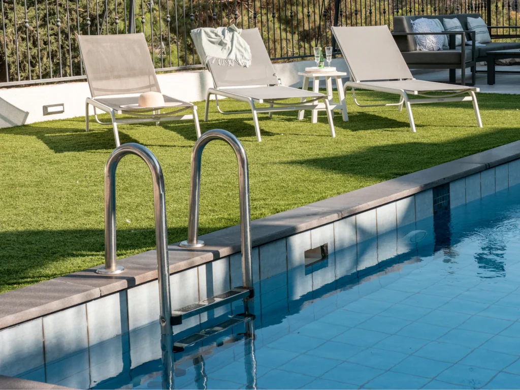 Backyard pool with paver coping and lounge chairs at a private home
